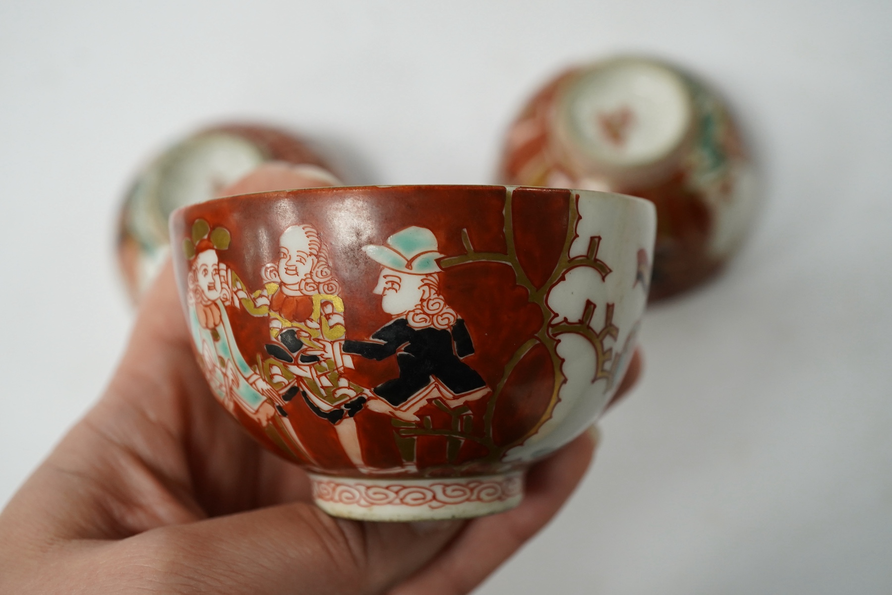 Three Imari ‘Black Ship’ teabowls, Meiji period, 8.5cm in diameter. Condition - good